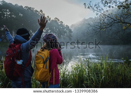 Couples who love to travel, take pictures Beatiful nature at Pang ung lake and pine forest at Mae Hong Son in Thailand.