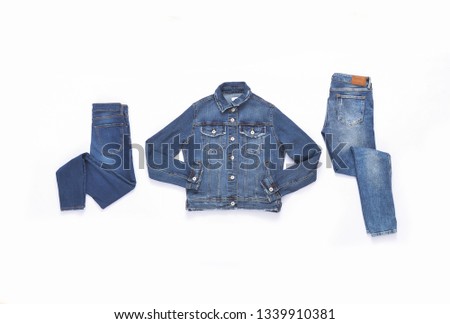 Two blue jeans and jeans jacket on white background
