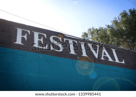 Aged festival sign with bright sun flare                              