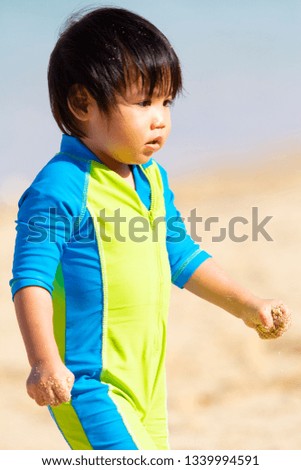Asian Boy Playing On The Beach