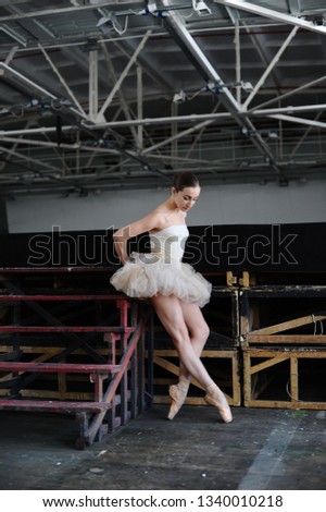 ballerina in a beautiful short dress behind the stage of the theater