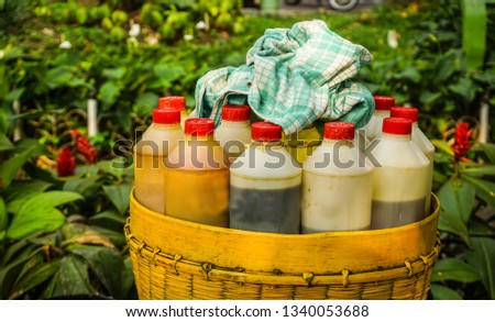traditional herb drink or jamu from Indonesia with vintage style bottle on bamboo basket Royalty-Free Stock Photo #1340053688