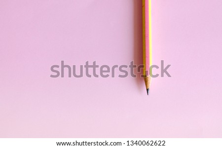 Pencil put on a pink background, write a concept.
