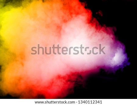 multi color smoke flow after explore on black background 
