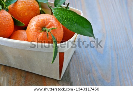 A lot of mandarin orange or mandarine in basket for sale in supermaket with wooden floor