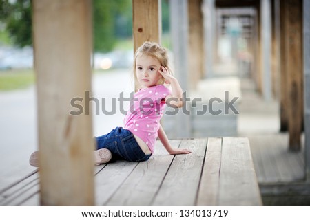 Adorable little girl portrait outdoors at summer