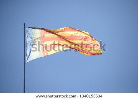 the valencian flag in the wind at spanish sky, spain