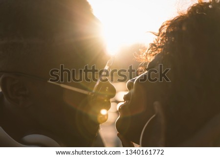 Close-up couple of African boy and girl kissing.