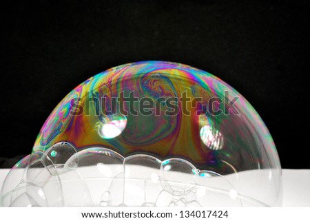 colorful soap bubbles with black reflective background