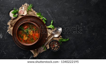 Harcho soup with meat and tomatoes. Ukrainian cuisine. Top view. Free space for your text. Rustic style.