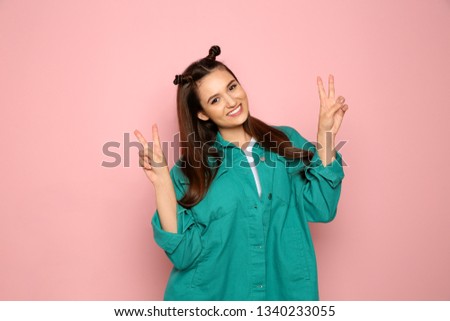 Portrait of beautiful young woman in stylish clothes on color background