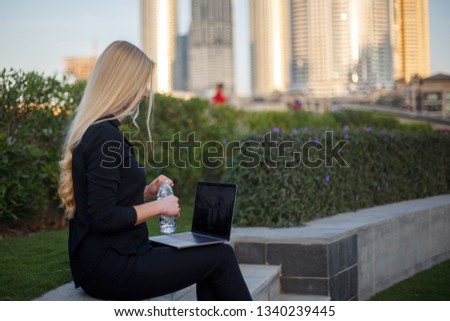 Young woman use phone and laptop on Dubai
