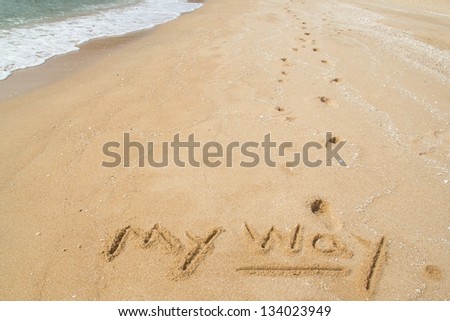 Footprints on the beach and the word MY WAY.