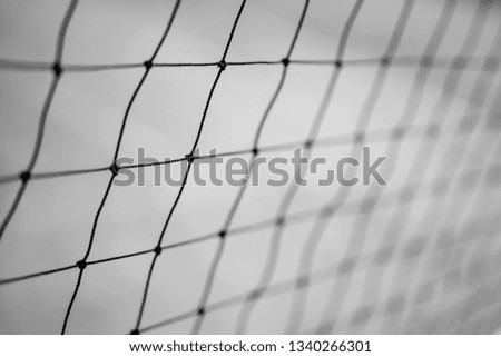 Black and white closeup image of sports netting. 