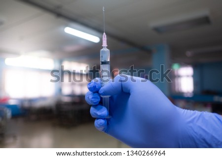 Nurse holding syringe with medicine 