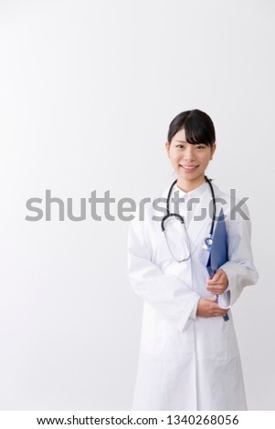 Young woman wearing a white coat