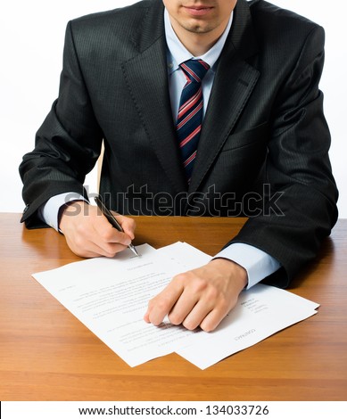 Close up of businessman signing a contrac