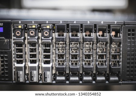Close up of hard disk dock in front of a rack server in server room where hard drives are installed to store the information