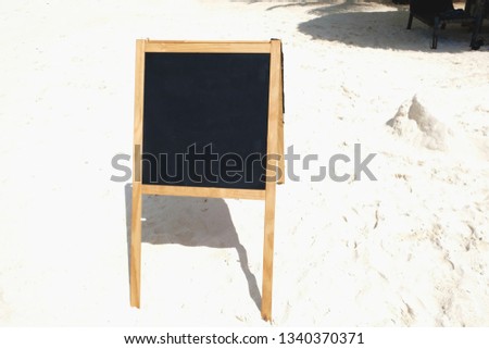 Blackboard message board on the beach on a sunny summer hot day