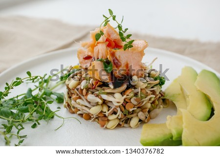Salad of germinated seeds, trout and avocado. Macrobiotic food concept