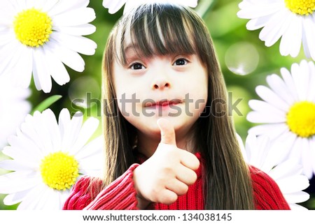 Portrait of beautiful young girl on the background of sunny chamomile flowers