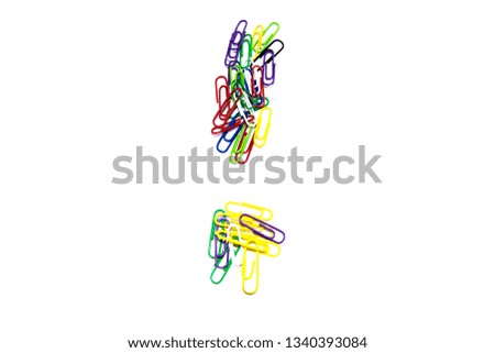 Exclamation mark from color clips, with soft blur at the bottom, on a white background.