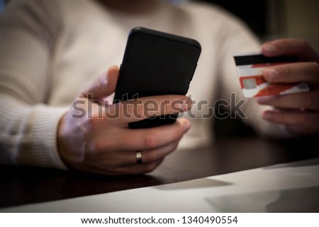 Man holding phone and credit card  ,close up photo.