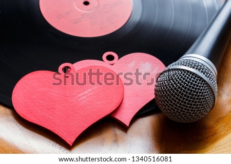 Song for lovers. Nostalgic songs, concept with vinyl records, microphone and hearts. Royalty-Free Stock Photo #1340516081