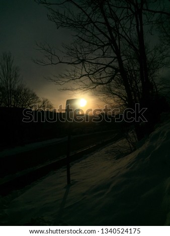 picture of the sun rising in the winter time