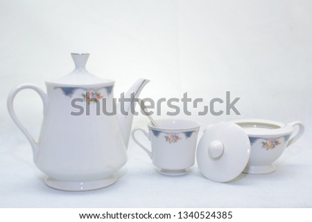 Mock up / design set of elegant and traditional teapot colorful white and blue coffee cup & Tea cup on cup's plate beside the hot tea pot , design/ drink-ware isolated on white background