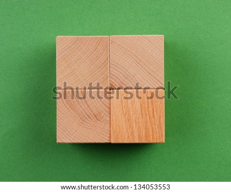 wooden geometric shapes on a green background