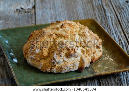                       Irish soda bread with whole wheat flour on platter on a rustic table top       
