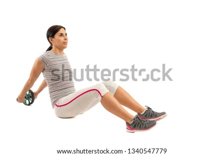 Girl with a gymnastic roller on white background