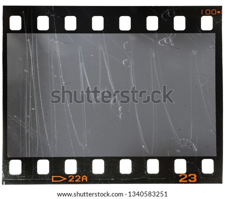 scratched real 35mm film material type 135, photo or movie strip on white background isolated