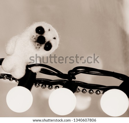 plush toy seal sits on the wires with light bulbs