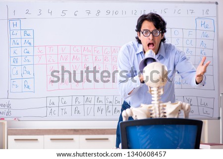 Young male chemist teacher and student skeleton 