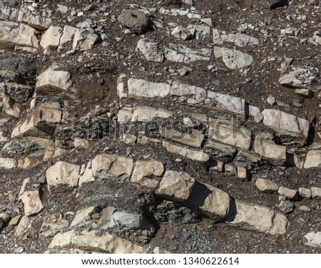 Shale mountains cement pits. The texture of the stone wall. Large cracks, the separation of the stone ridge. Background of stone wall texture.  construction cement production