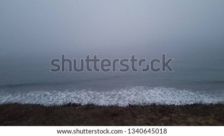Overcast at the beach with crashing waves