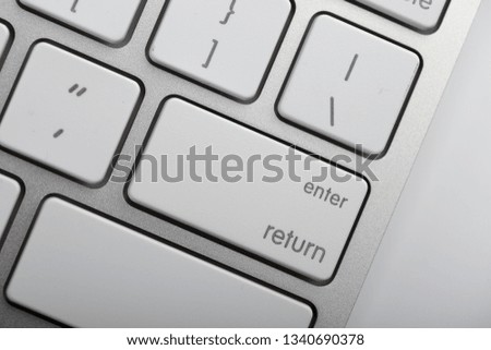 Closeup shot of white keyboard on white background.