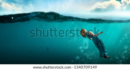 Woman dancer in clear blue water