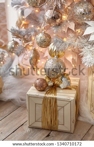 Beautiful New Year gift on a background of lights garlands.