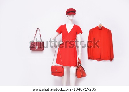 mannequin in. red sundress with hat, two handbag and red long shirts ,skirt on hanging on white background
