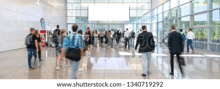 blurred business people at a trade fair, banner size, including Copy space