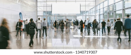 blurred business people at a trade fair, banner size, including Copy space