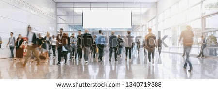 blurred business people at a trade fair, banner size