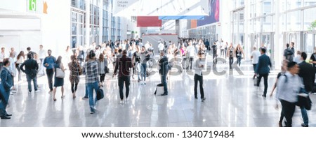 blurred business people at a trade fair, banner size