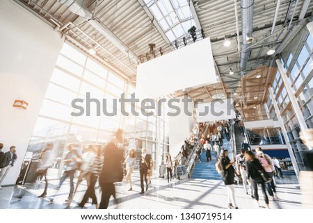 blurred business people at a trade fair, including Copy space