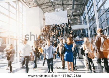 Crowd of anonymous people walking, with copy space banner