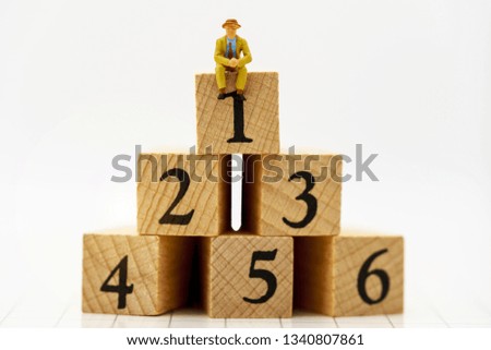 Miniature people: Business people sitting on wooden box with number 1,2,3,4,5 and 6. Business career growth,  achievement, success., victory or top ranking Concept.