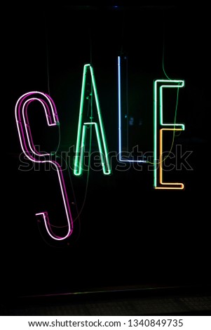 Neon Lights Sale Sign in Shop Window